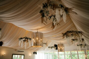 Elegant Event Venue with Draped Ceiling and Chandeliers