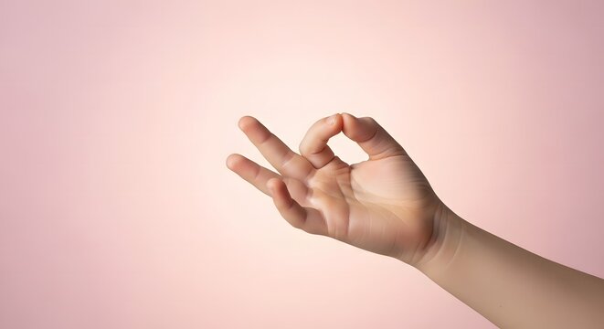 Child hand, Hand showing Ok Gesture on Pale Pink Background for Positive Aff
