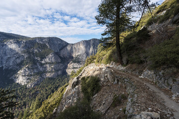 Switchback section of the Four Mile Trail above Yosemite Valley in Yosemite National Park California.   Yosemite falls is in the background.  