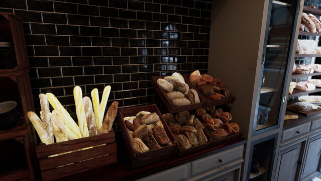 A variety of breads and pastries are neatly arranged on store shelves in a bustling bakery.