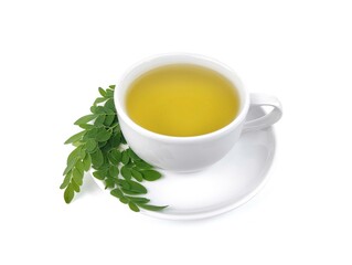 Moringa tea (moringa oleifera) in cup on white background. Herbal drink for health. High angle view 