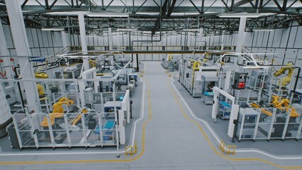 Yellow Collaborative Robotic Arms Actively Working Together With Robots on Production Conveyor System in Vast, Modern Industrial Space. Concept of Industry 4.0, Unmanned, Large Scale Manufacturing.