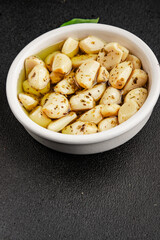 Garlic slices in flavored oil roasted garlic slice in oil fast food natural tasty appetizer fresh delicious gourmet food background on the table rustic top view copy space vegetarian or vegan food