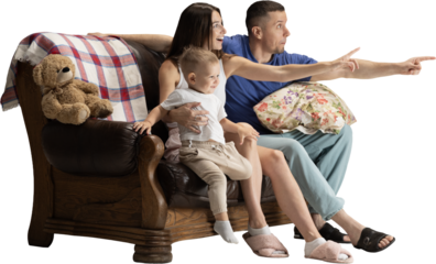 Happy family sitting on sofa and pointing forward with joyful emotions on transparent background. Concept of family lifestyle, parenting visuals, home comfort, advertising scenes and warm storytelling