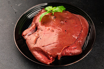 Liver raw veal or pork meat offal baked natural tasty appetizer fresh delicious gourmet food background on the table rustic top view copy space keto or paleo diet