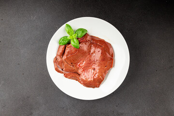 Liver raw veal or pork meat offal baked natural tasty appetizer fresh delicious gourmet food background on the table rustic top view copy space keto or paleo diet