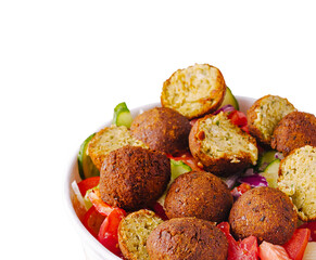 Delicious falafel served over fresh salad in a vibrant bowl
