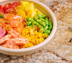 Salad bowl with fresh vegetables and seafood on a marble countertop