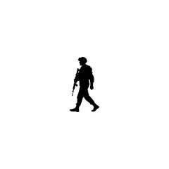 Fototapeta premium A silhouette of a soldier walking with a rifle in hand wearing a helmet and military uniform in black color