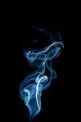 Blue hot curly steam smoke isolated on black background. Abstract background, design element, for overlay on pictures. Create mystical Halloween photos, for overlay on pictures.