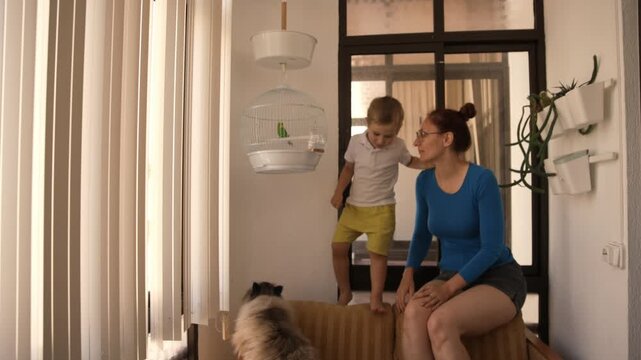 Mother and son spending time together at home with pets