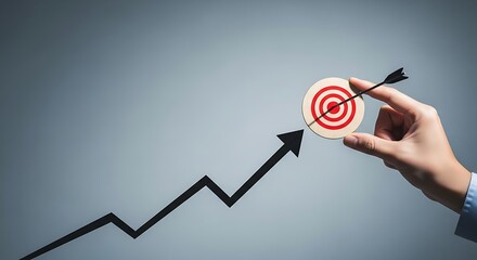 Hand holding target with arrow, growth chart, success and achievement concept