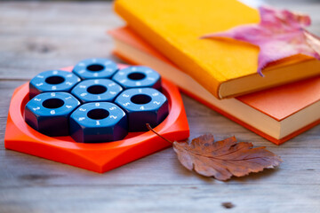 Female Hand placing numbered hexagonal puzzle pieces educational game board, developing logic and math skills, STEM toy, seasonal health, mental exercise, cognitive development, problem solving