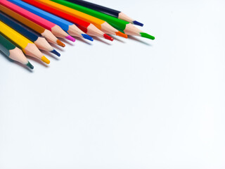 Colored pencils placed on a white background