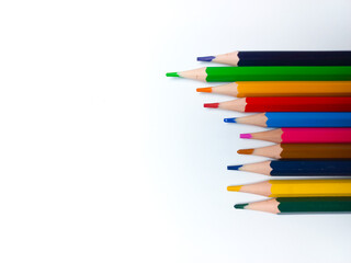 Colored pencils placed on a white background