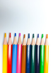 Colored pencils placed on a white background