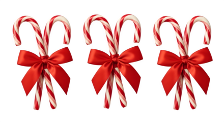 Three candy canes with red bows isolated on transparent background