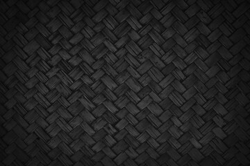 Old black bamboo weave texture background, pattern of woven rattan mat in vintage style.