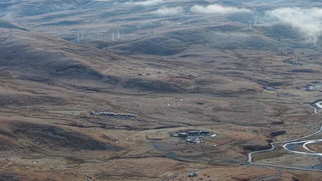 Morning Aerial Tilt-Up Reveal of Yala Snow Mountain