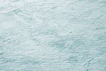 Textured light blue green plaster surface with rough patterns and subtle natural brush strokes
