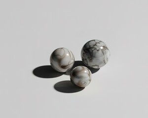 Three marbled spheres of varying sizes on a white background balls marbles
