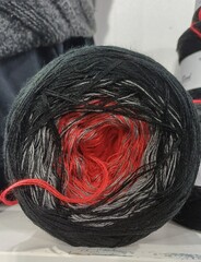 Gradient yarn ball showing red black grey colors