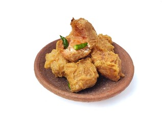 Gehu or Indonesian food made from fried tofu filled with bean sprouts and spices on plate isolated on white background. High angle view