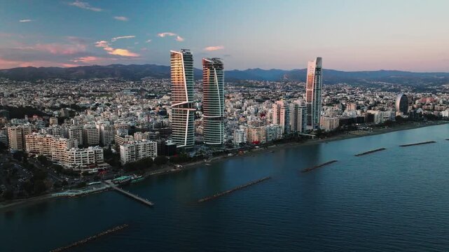Sunset Over Limassol, Cyprus. Aerial Perspectives of Limassol's Modern Urban Landscape with High-Rise Glass Structures.