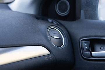 Car interior focusing on air vent and control panel design in modern vehicle