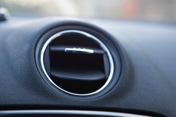 Close-up view of car air vent showcasing design and functionality from the interior perspective