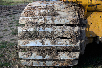 Crawler tractor bulldozer track close up shot. Heavy industrial tracked bulldozer detailing.