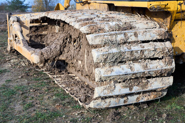 Crawler tractor bulldozer track close up shot. Heavy industrial tracked bulldozer detailing.