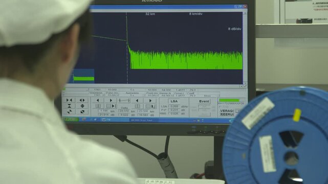 Engineer Analyzing Signal Waveform Data on Industrial Monitor