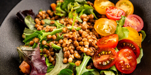 Lentil salad vegetables, tomato, green leaf lettuce tasty snack fresh delicious gourmet food table setting rustic top view copy space keto and paleo diet vegetarian and vegan food