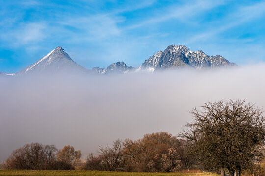 Snowy High Tatras peaks rising above inversion fog; mountains can be treacherous and dangerous in low visibility conditions.