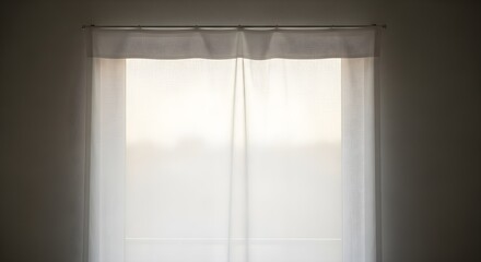 Window with white curtains and sunlight streaming through a bright opening