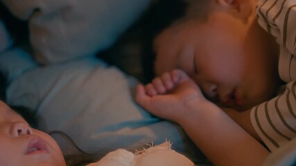 Two Asian siblings sleeping side by side in cozy bedroom at night, enjoying calm and peaceful bedtime in warm home environment - Powered by Adobe