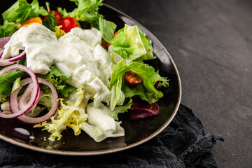 Burrata salad tomato, purple onion, green leaf lettuce tasty snack fresh gourmet food table setting rustic food top view copy space keto and paleo diet vegetarian food