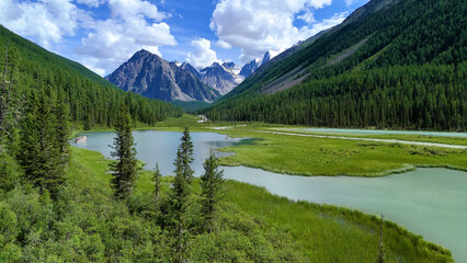 Drone flight over a mountain lake - Shavlinskoye blue lake in Altai
