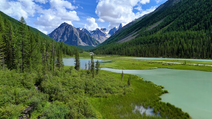 Drone flight over a mountain lake - Shavlinskoye blue lake in Altai
