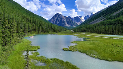Drone flight over a mountain lake - Shavlinskoye blue lake in Altai