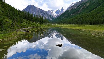Drone flight over a mountain lake - Shavlinskoye blue lake in Altai