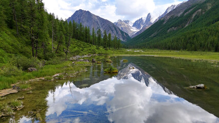 Drone flight over a mountain lake - Shavlinskoye blue lake in Altai