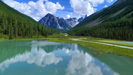 Drone flight over a mountain lake - Shavlinskoye blue lake in Altai