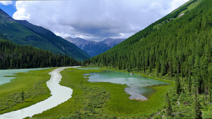 Drone flight over a mountain lake - Shavlinskoye blue lake in Altai