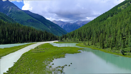 Drone flight over a mountain lake - Shavlinskoye blue lake in Altai