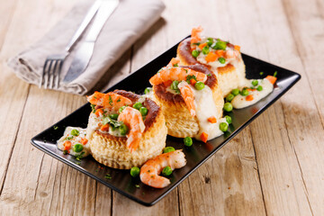 puff pastry with shrimp, pea and cream. french dish, vol au vent