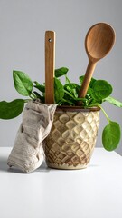 Greens in textured pot with wooden spoons & cloth