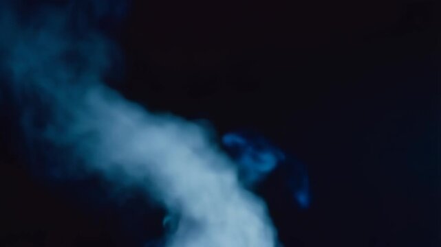 Mysterious Blue Smoke Against Dark Background - Abstract Art and Design Concept