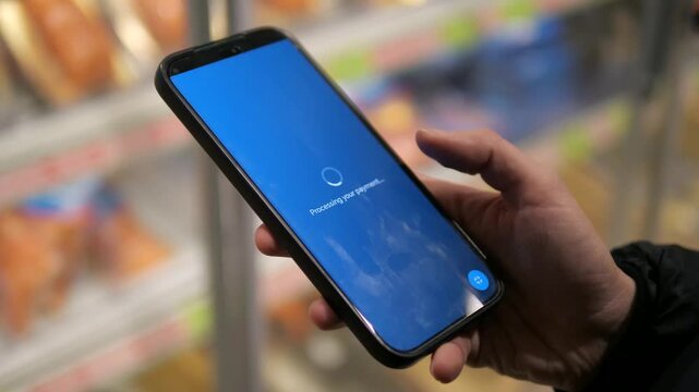 Closeup of a womans hands in a supermarket finalizing a grocery delivery order. The clip shows her reviewing the terms and price, clicking a secure payment link, and being redirected to a successful